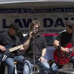 Singer on stage with band at Goodwin & Scieszka's Law Day