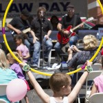 Boy holding hula hoop up in front of band