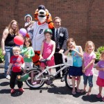 Children Posing with Bike and Paws Mascot