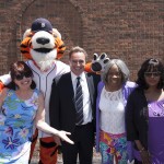 Group of people posing with Detroit Tigers mascot at Law Day event