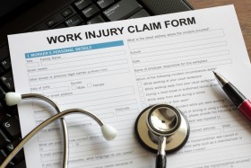 Work Injury Claim Form with stethoscope and pen