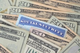 Social Security card amongst dollar bills