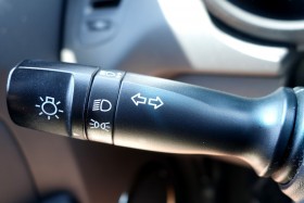 Close up view of a turn signal lever inside a vehicle