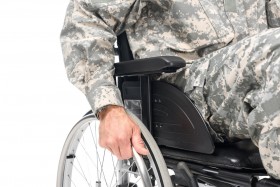 Man in army uniform in wheelchair