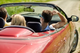 Group of young adults riding in convertible