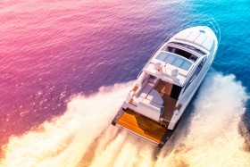 Large luxury yacht riding through open water