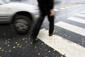 Pedestrian walking at walkcross in front of moving car