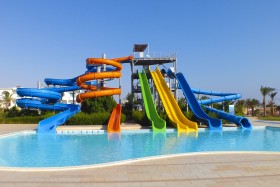 Outdoor water park with six water slides leading to pool