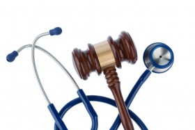 Blue stethoscope and wooden gavel