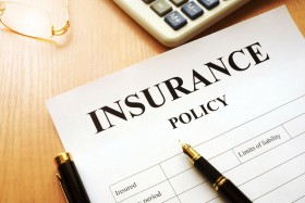 Insurance policy with pen and calculator