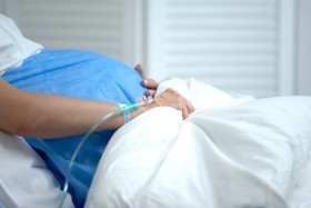 Pregnant woman in a hospital bed.