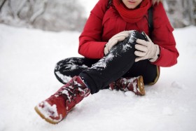 Woman with an injured leg after falling in the snow.