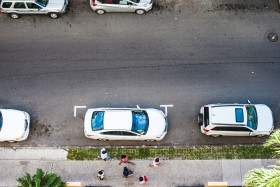 Overhead view of cars parallel parked on a street.