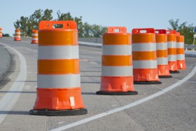 Orange construction barrels on road
