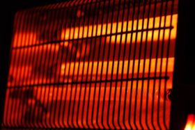 Close-up of the glowing red grill of a space heater.