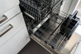 Views of an open dishwasher with the trays pulled out.