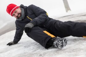 A man in pain after falling on some ice.