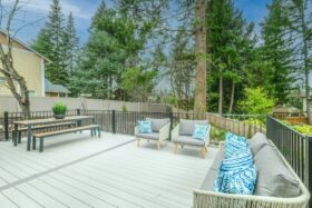 Backyard deck with sofa and picnic table.